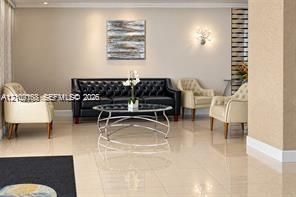 Polished large-format tile flooring, textured wall finishes, and decorative wall-mounted lighting fixtures
