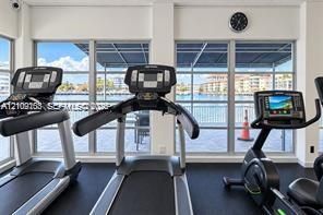 Fitness room featuring floor-to-ceiling windows and water-fronting exterior exposure