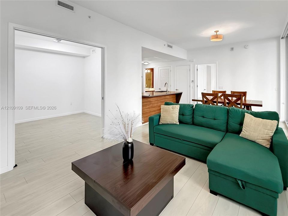 Interior space featuring wood-finish flooring, recessed lighting, and kitchen cabinetry with a peninsula island