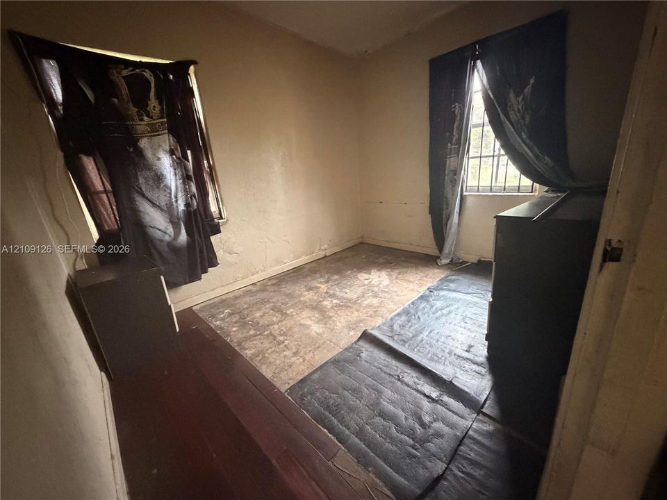 Interior room featuring two windows with security bars