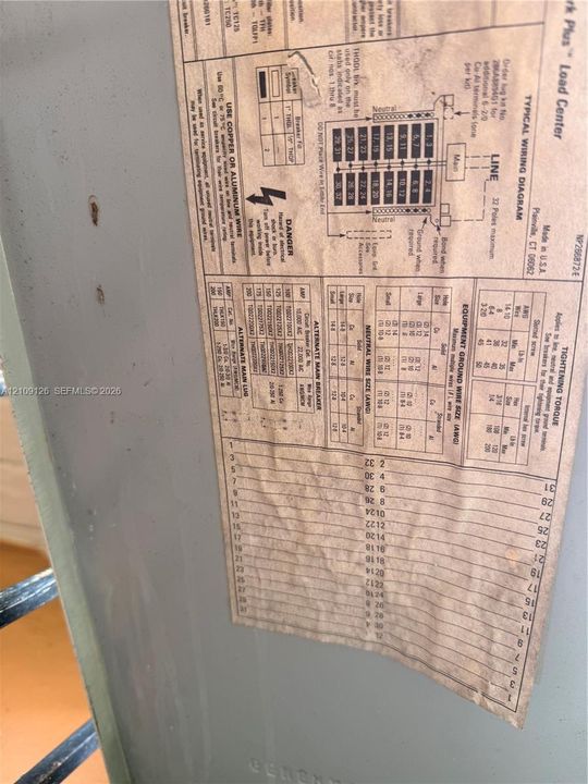 Load center electrical panel with a 32-pole capacity and integrated technical wiring diagram