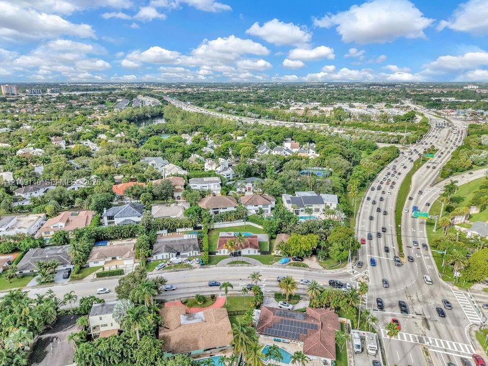Aerial perspective of a residential area featuring mature tree canopy and established neighborhood infrastructure