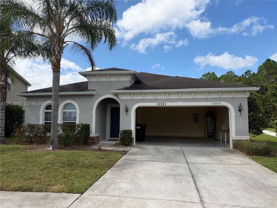 Exterior side elevation featuring a stucco finish, shingle roof, double-pane windows, and a landscaped lawn