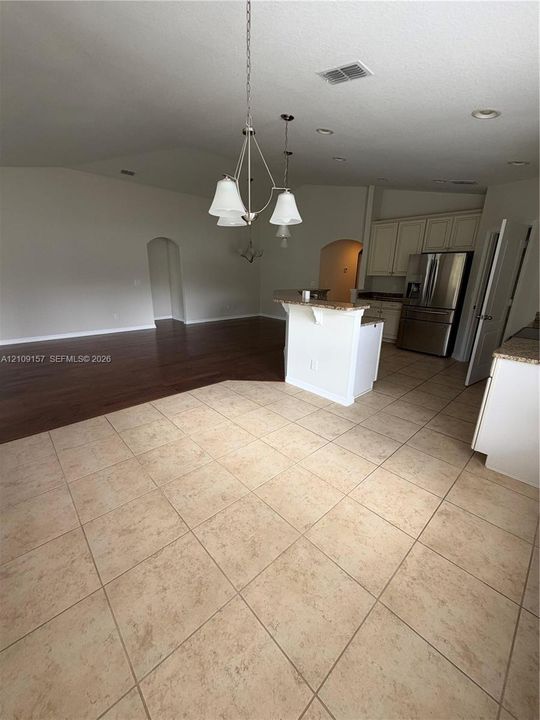 Ceramic tile flooring, arched interior doorway, and closet featuring a wire shelving system