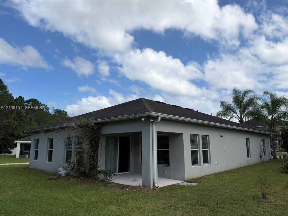 Stucco exterior with a hip roof, integrated covered patio, and multi-pane windows