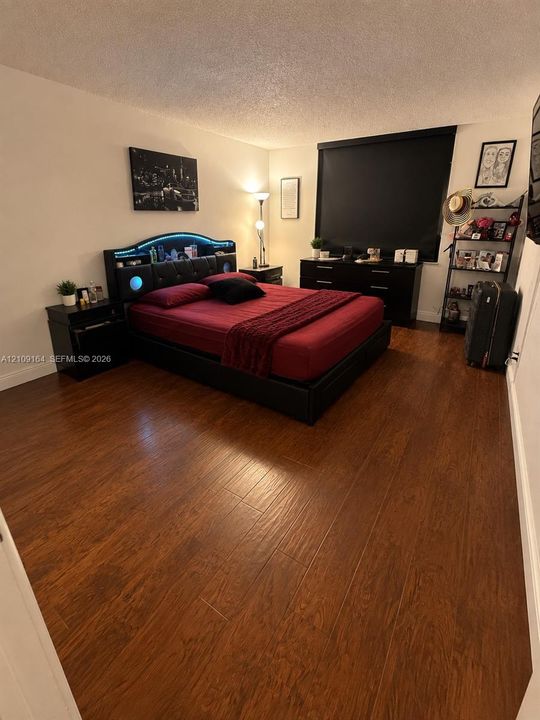 Wood-finish flooring throughout and a blackout window shade