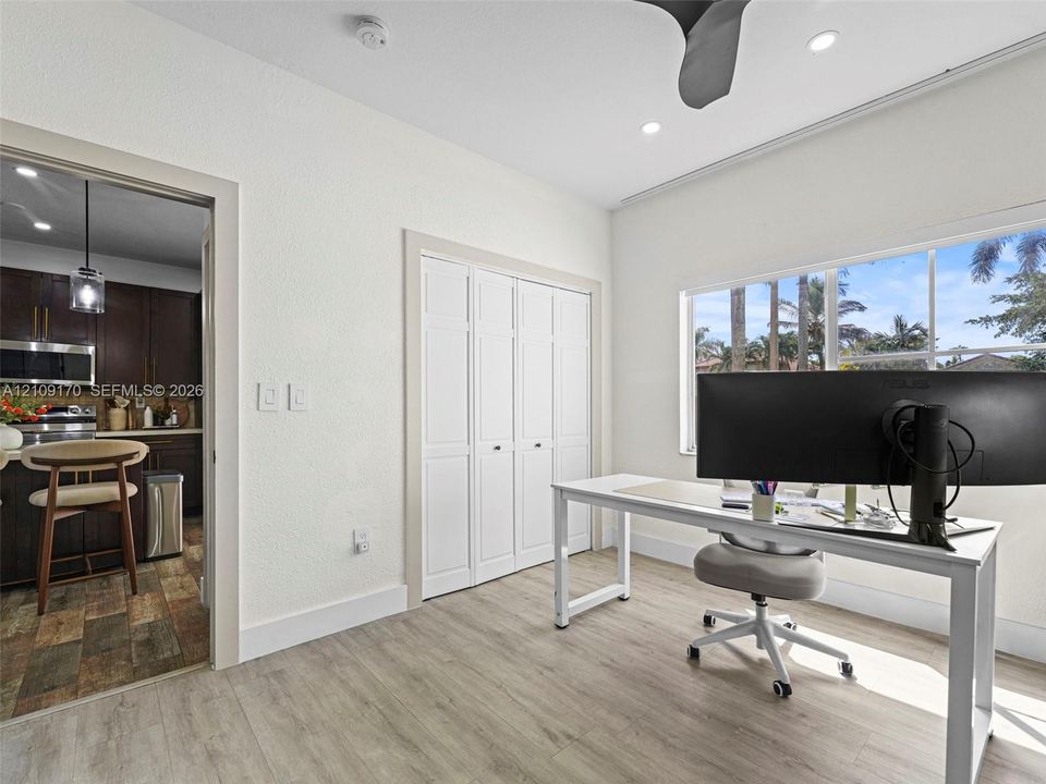 Room featuring light wood-finish flooring, recessed lighting, ceiling fan, and white bifold closet doors