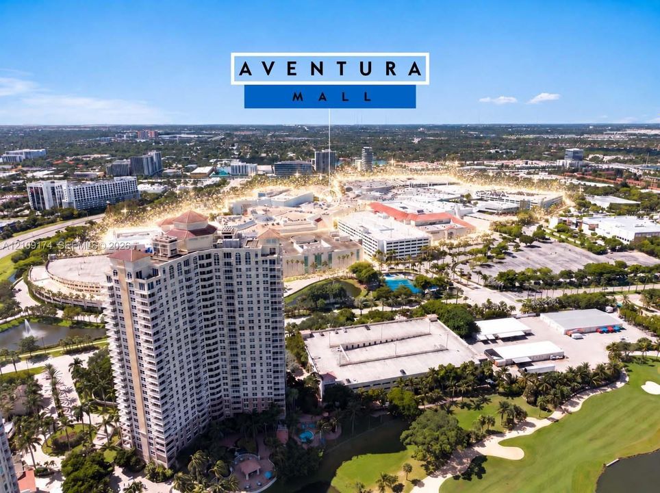 Aerial perspective of high-rise residential architecture featuring surrounding mature landscaping, water features, and expansive golf course grounds