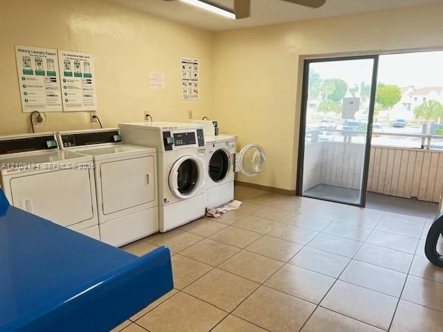 Laundry featuring dual industrial tile flooring, and ceiling fan