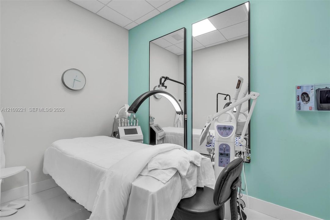 Dual full-length wall-mounted mirrors and drop ceiling tiles