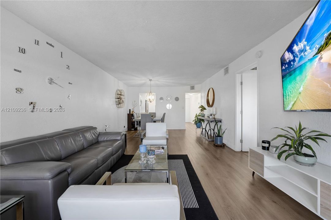 Spacious living area featuring wood-finish flooring and a neutral color palette