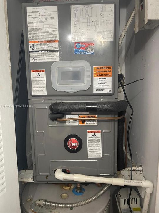 Rheem HVAC system with insulated piping and attached drainage conduit