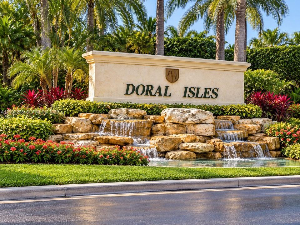 Community monument sign featuring multi-tiered natural stone water features, integrated landscaping, and mature palm trees