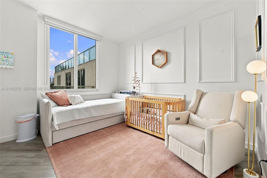 Interior space featuring wood-finish flooring, decorative wall molding, and a large window
