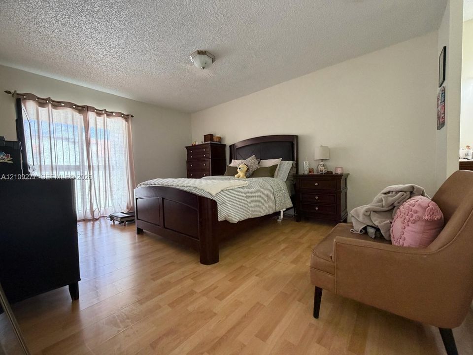 Wood-finish flooring, sliding glass door, and flush-mount ceiling lighting