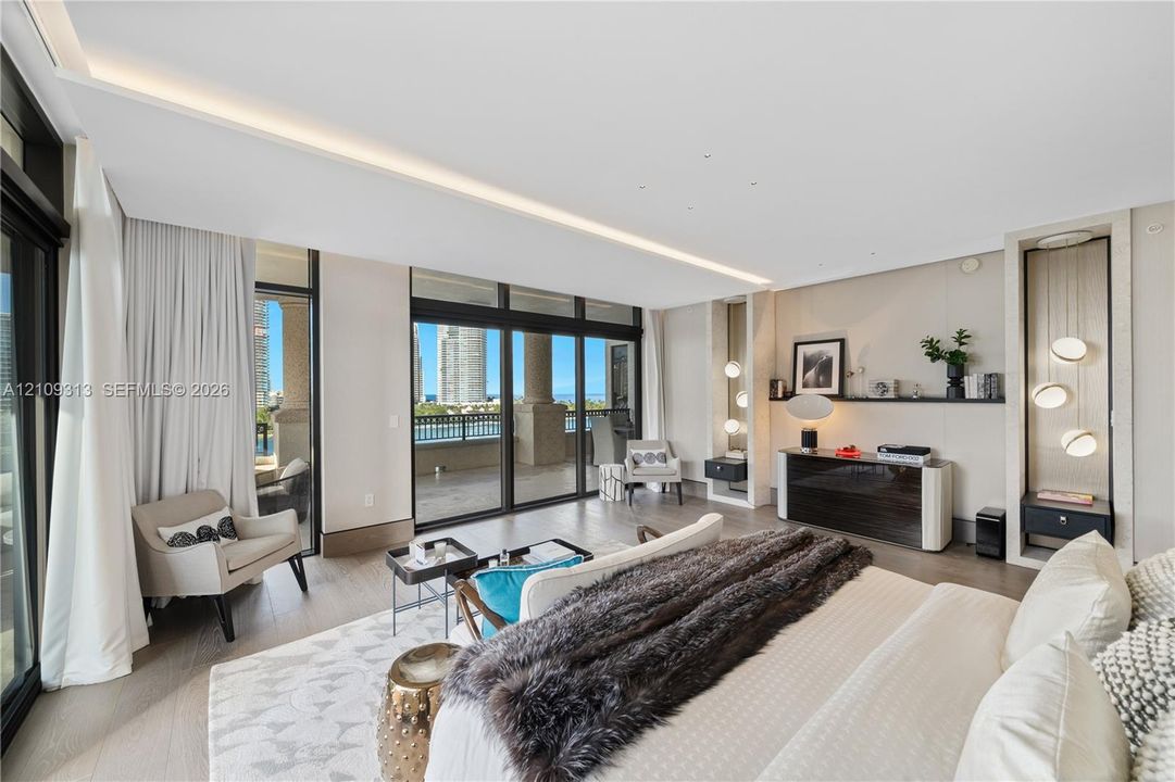 Floor-to-ceiling sliding glass doors, built-in recessed shelving with integrated accent lighting, light-toned wood-finish flooring, and a covered balcony