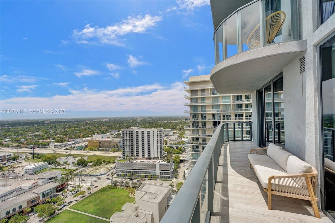 High-rise balcony featuring tile flooring and glass panel railings