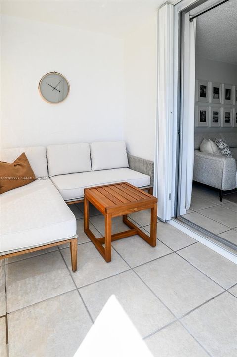 Balcony featuring large-format ceramic tile flooring and floor-to-ceiling sliding glass doors
