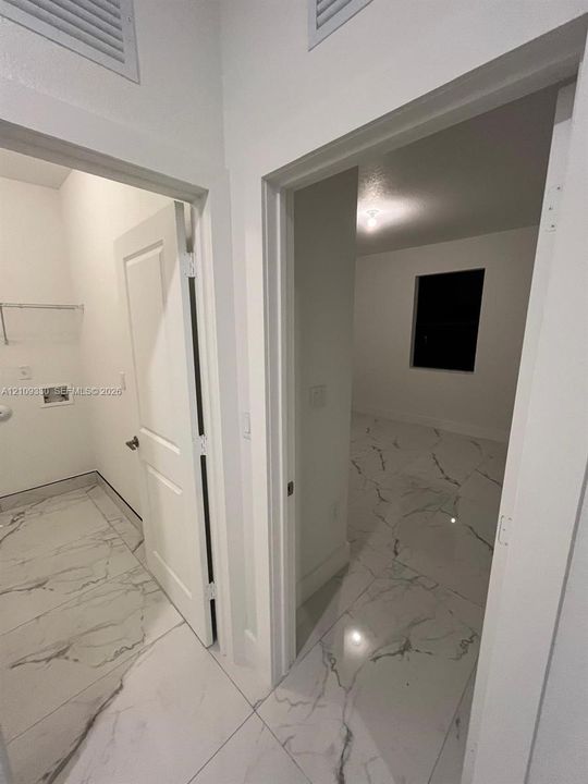 Large-format stone-look tile flooring, solid-core interior doors, and dedicated laundry utility connections
