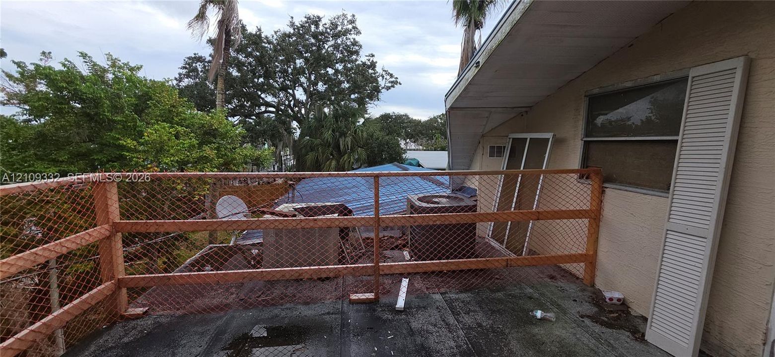 Exterior elevated deck featuring wood-framed railing with integrated wire mesh