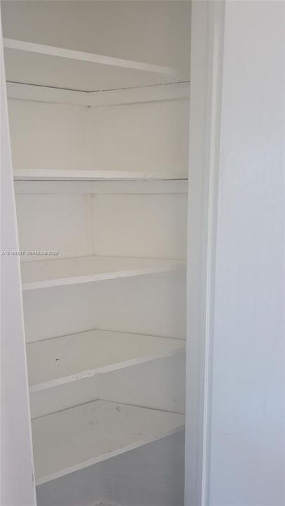 Built-in storage cabinet featuring five tiered shelves