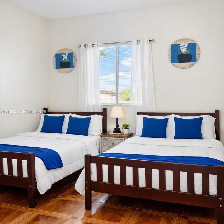 Neutral interior room featuring wood-finish flooring, a double-hung window, and white wall finishes