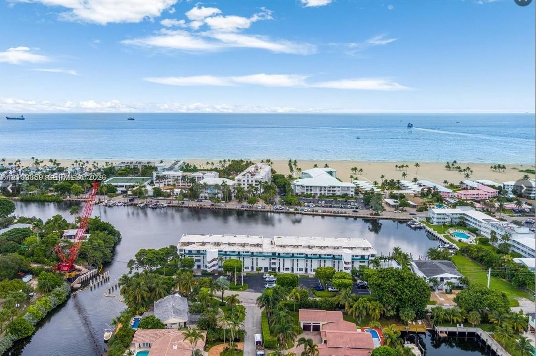 Aerial perspective featuring direct oceanfront access, pristine sandy shoreline, and waterfront proximity