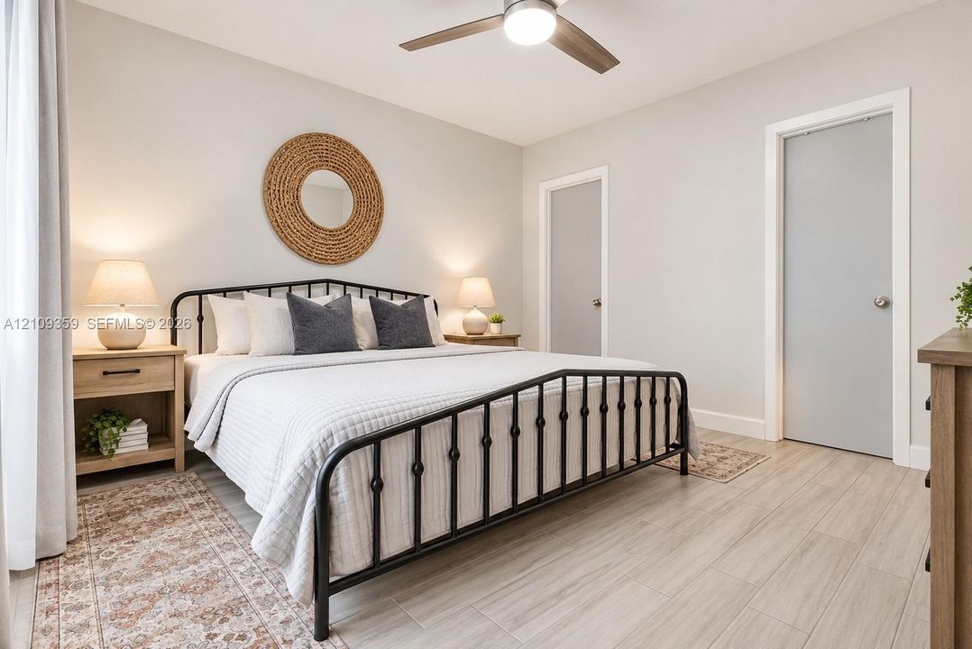 Neutral wall color, wood-finish flooring, and a ceiling fan with integrated lighting