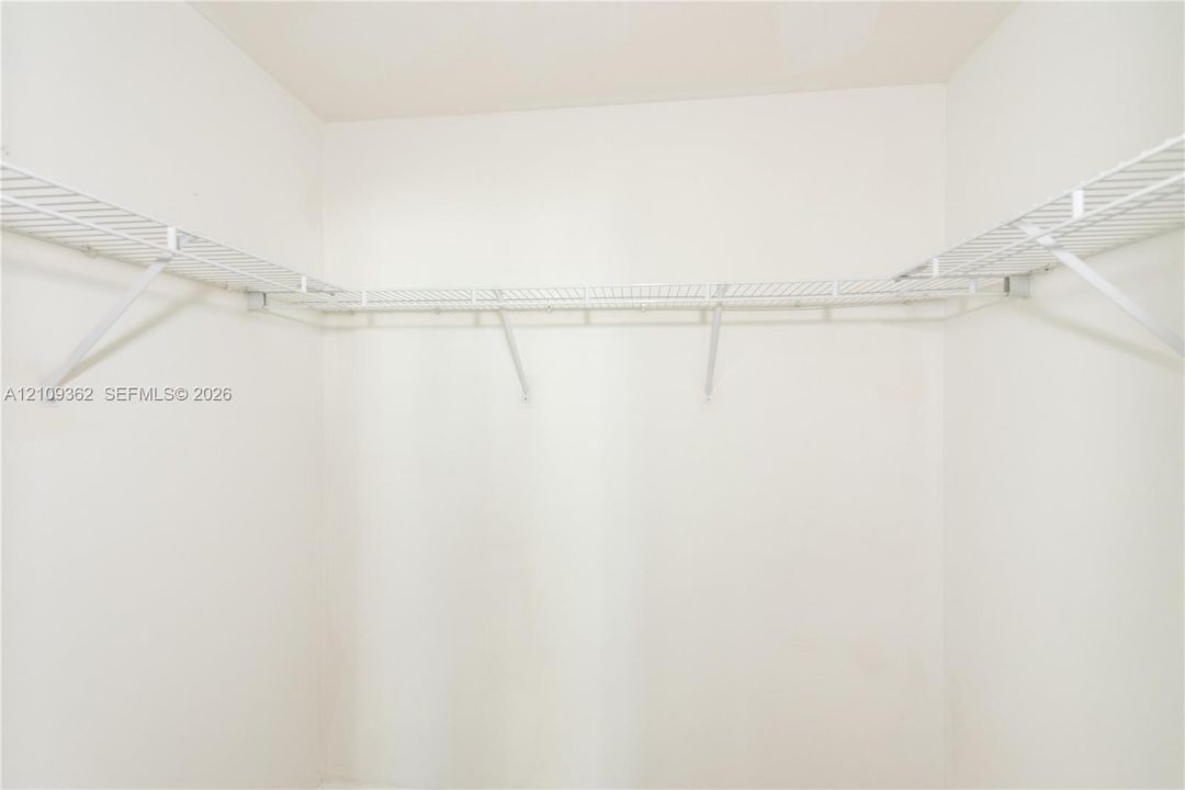 Walk-in closet featuring white wire shelving