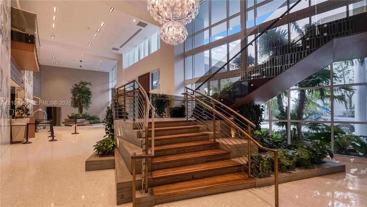 Stairs leading to main comon area floor to mailroom, fitness center, garage and other areas.
