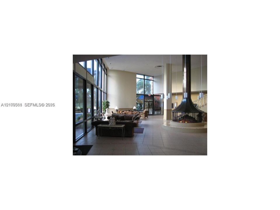 Floor-to-ceiling windows, circular suspended metal fireplace, tiled flooring, high ceilings, and recessed lighting