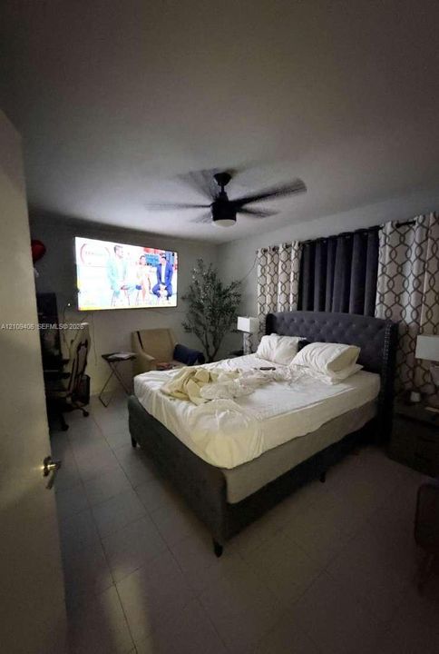 Room featuring tile flooring and a central ceiling fan