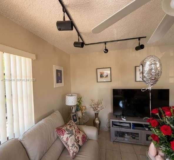 Matte black ceiling-mounted track lighting and vertical blinds