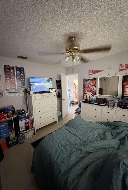 Room featuring a ceiling fan with integrated light fixture and neutral wall finish