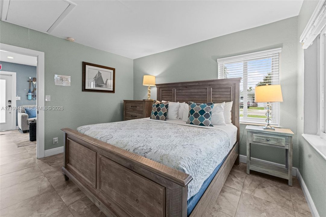Ceramic tile flooring, horizontal window blinds, and interior doors with decorative hardware