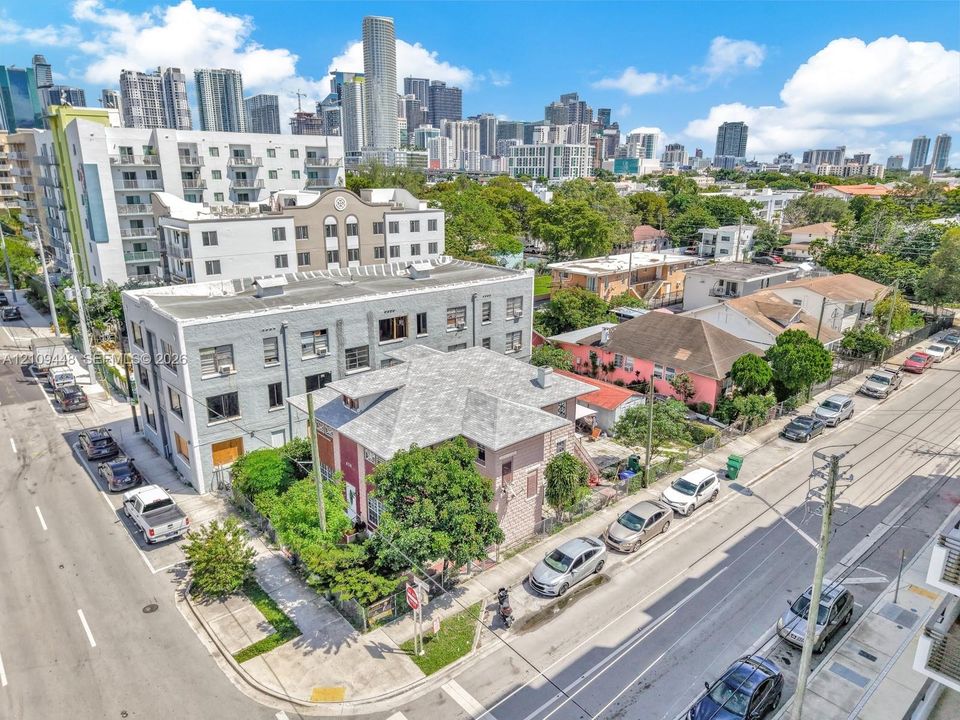 Corner-lot property featuring an urban setting with multi-story building architecture and proximity to a dense metropolitan skyline