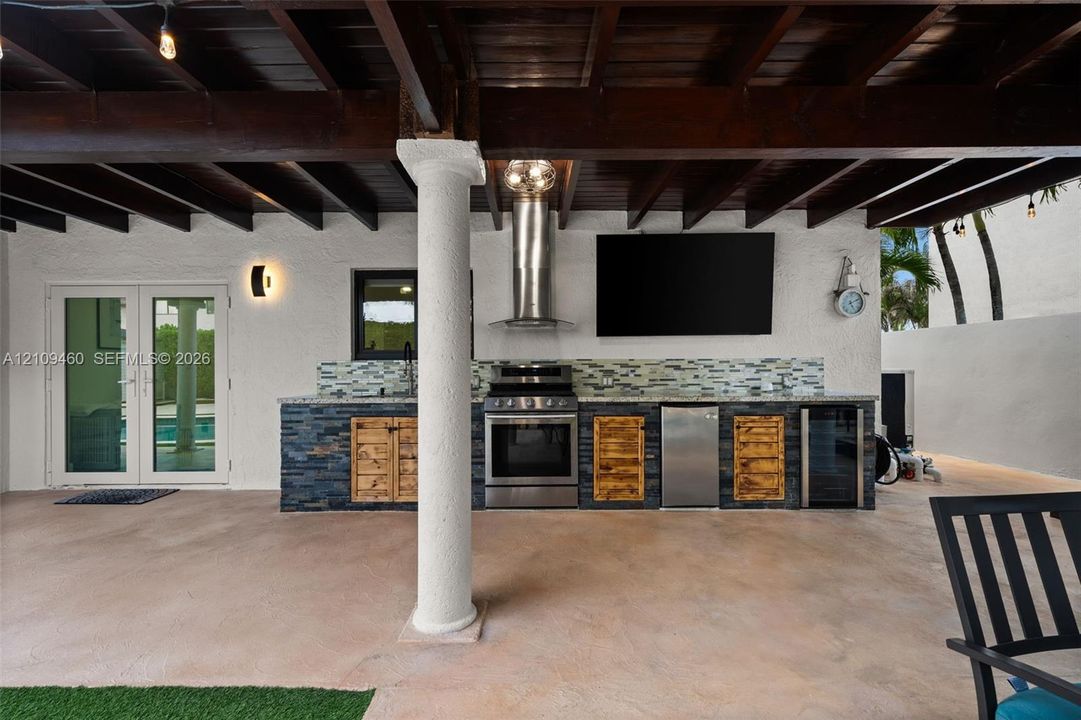 Outdoor kitchen with range, sink and beverage cooler