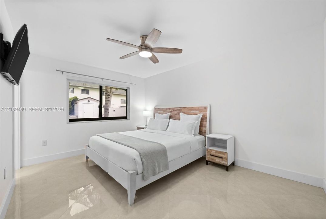 Primary bedroom with ceiling fan