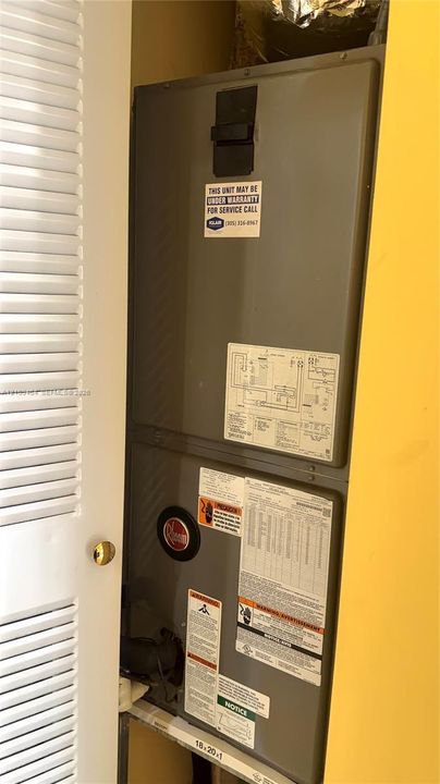 Climate control system housed within a utility closet featuring louvered door access