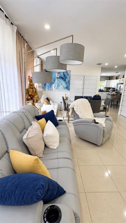 Neutral-toned tile flooring, recessed ceiling lighting, and floor-to-ceiling windows