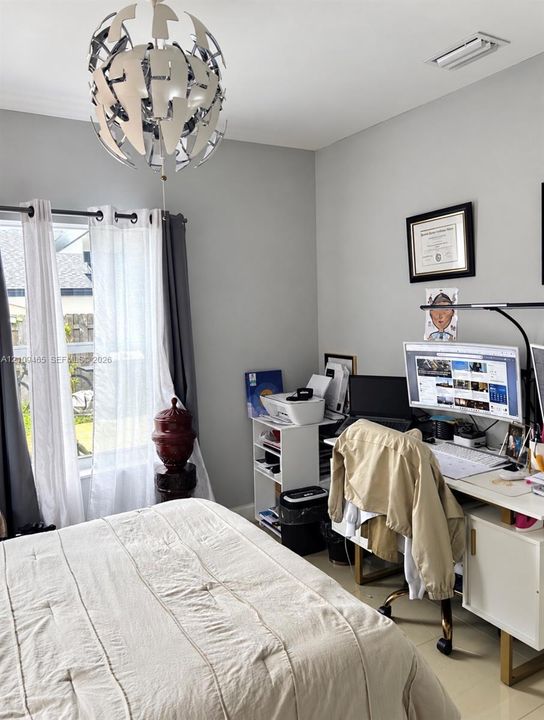Interior room featuring large format tile flooring, neutral wall paint, and a decorative modern sphere chandelier