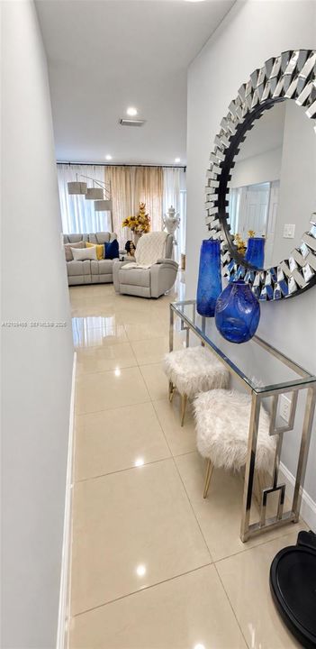 Polished large-format tile flooring and recessed lighting