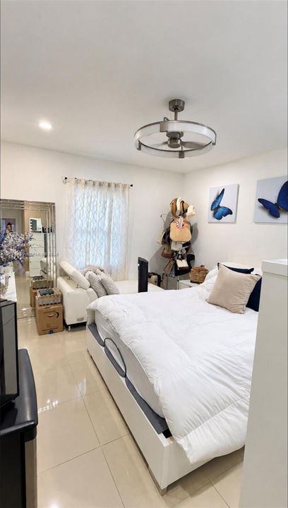 Polished tile flooring, recessed ceiling lighting, and a contemporary drum-style ceiling fan