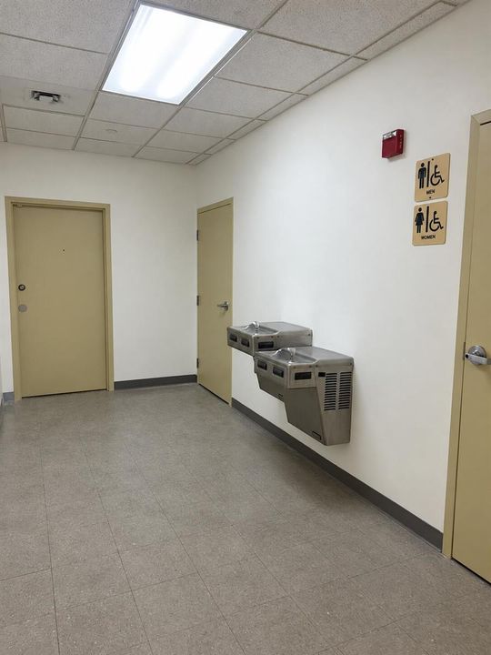 Institutional Hallway with Restroom Sign