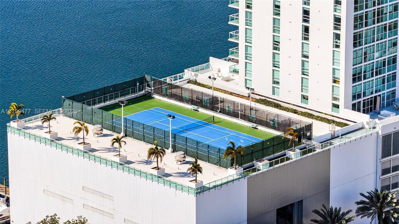 High-rise coastal architecture featuring glass-paneled balconies, floor-to-ceiling windows, and integrated boat slips along the waterfront