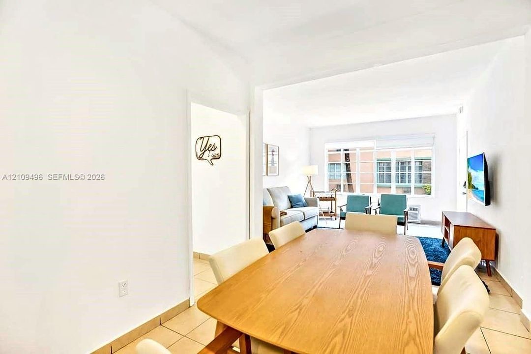 Neutral-toned ceramic tile flooring, multi-pane windows, and white wall finishes