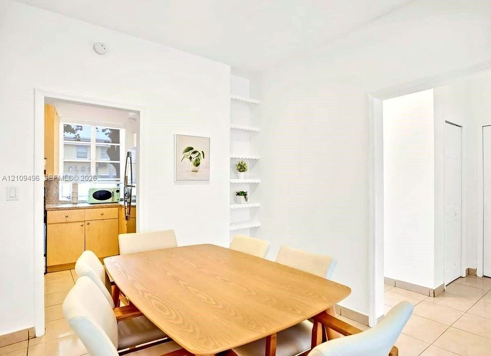 Interior space featuring tile flooring, built-in recessed shelving, and a double-door closet