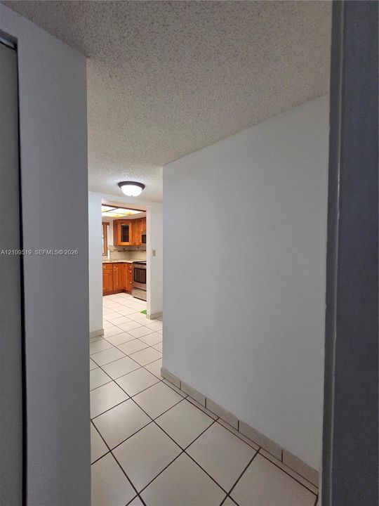 Unit encompasses entire ground floor  of  (3-story building)  exterior featuring smooth stucco siding, designated parking spaces, concrete stairways, and protective window awnings