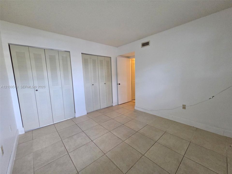 Second bedroom with natural light and two closets