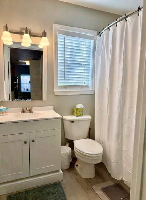 White vanity with integrated sink, chrome-finish faucet, and brushed nickel light fixture